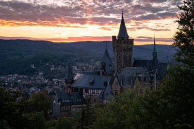 Buildings against sky at sunset