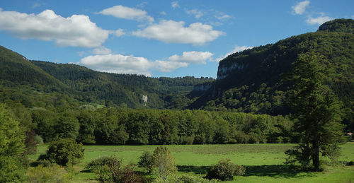 Scenic view of mountains against cloudy sky