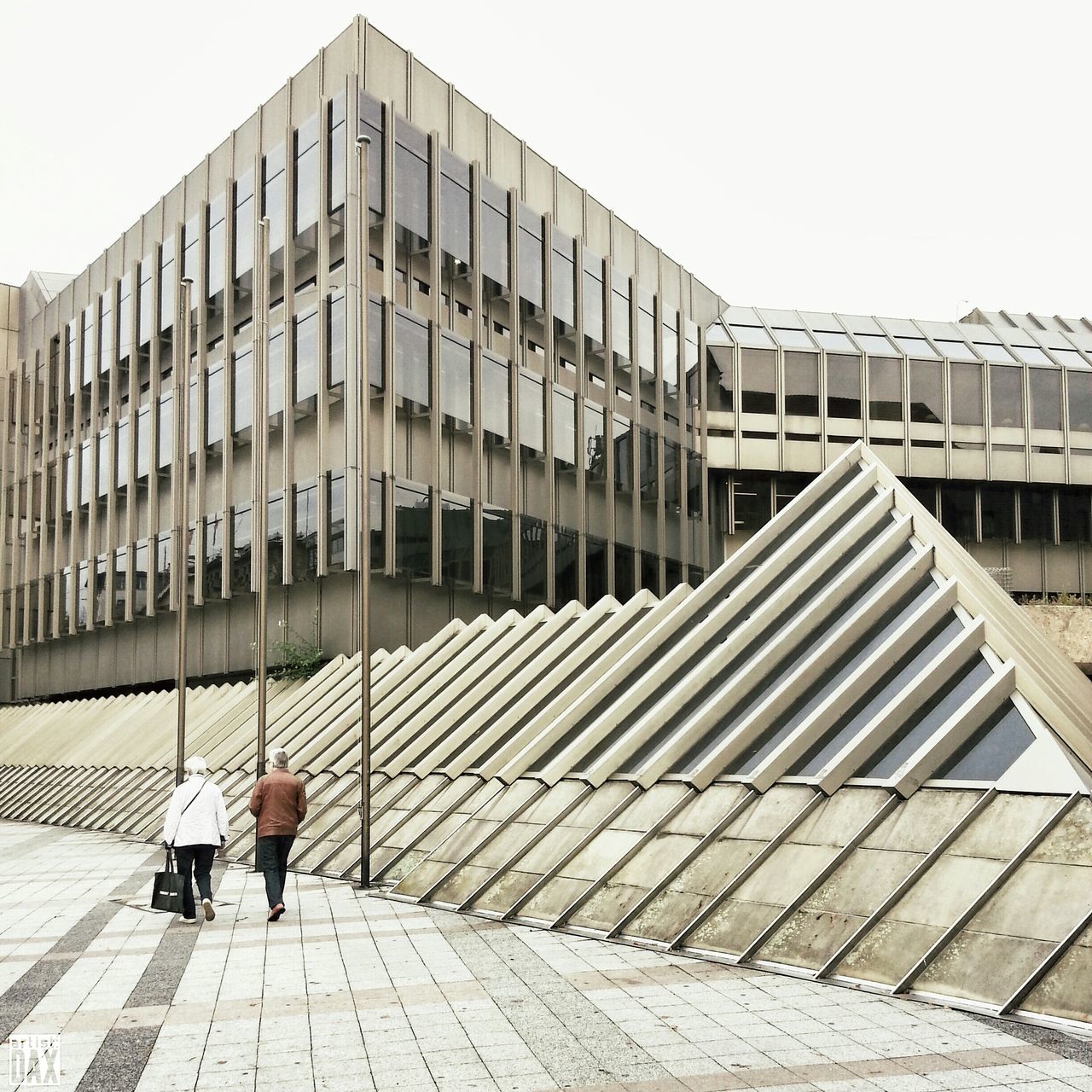 architecture, built structure, building exterior, walking, city, men, railing, building, clear sky, full length, lifestyles, modern, day, steps, office building, city life, outdoors