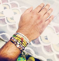 Midsection of man with woman on bed