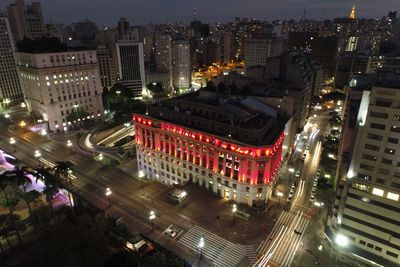 High angle view of illuminated city street and buildings at night