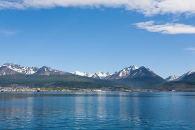 Scenic view of sea and mountains against sky