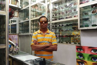 Portrait of man in sunglasses standing at store