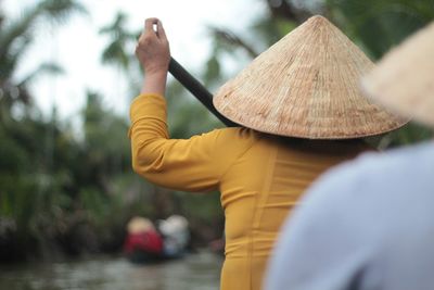 Rear view of people wearing asian style conical hats