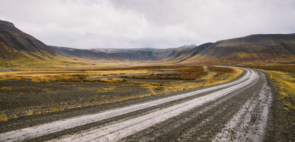 Panoramic view of road by mountains against sky