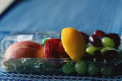 Close-up of fruits in plastic container on table