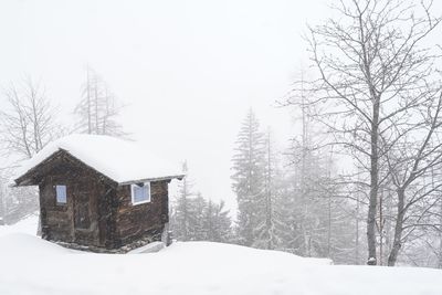 House on snow covered landscape