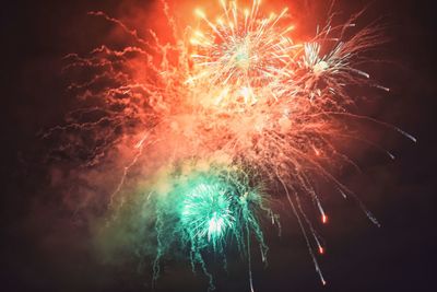 Low angle view of firework display at night