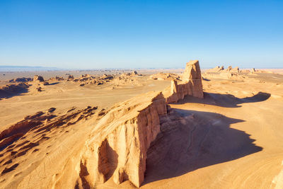 Panoramic view of desert against clear sky