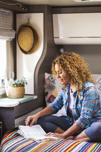 High angle view of young woman using mobile phone at home