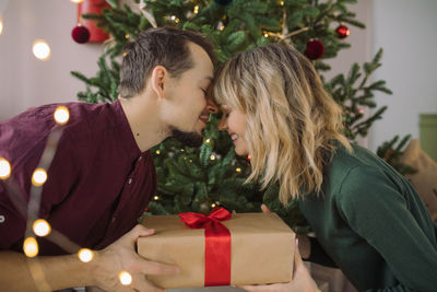 Woman with christmas tree in box