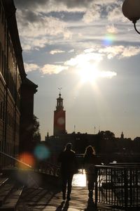 People walking in city at sunset