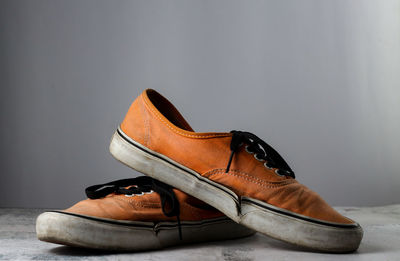 Close-up of shoes on floor against white background