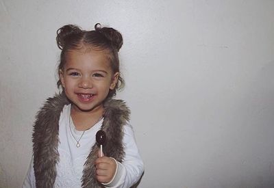 Portrait of smiling girl against white background