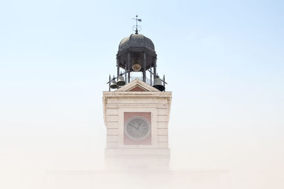 Low angle view of clock tower against clear sky