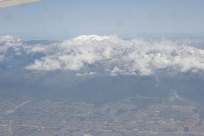 Aerial view of clouds over landscape against sky