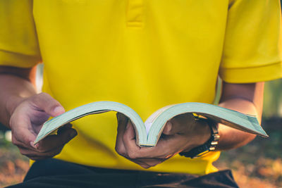 Close-up of man holding book