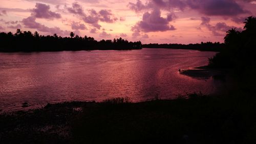 Scenic view of lake against sky at sunset