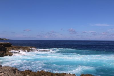 Scenic view of sea against clear blue sky