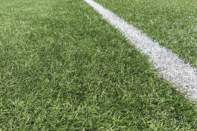 Soccer football background. green artificial grass soccer sports field with white stripe line