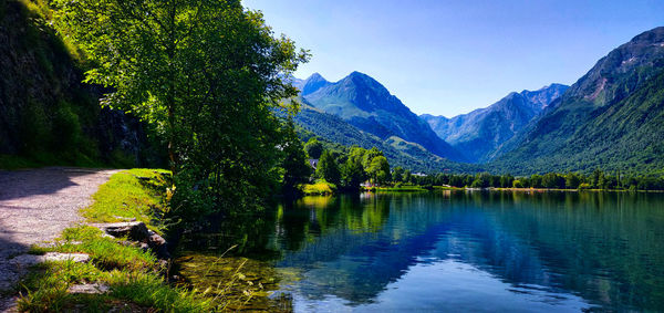 Scenic view of lake and mountains against sky