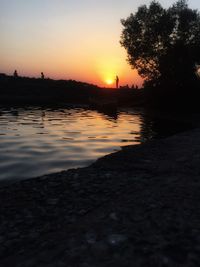 Scenic view of lake against sky during sunset