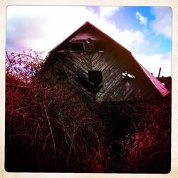Low angle view of building against cloudy sky