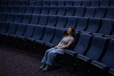 Rear view of woman sitting on stage theater