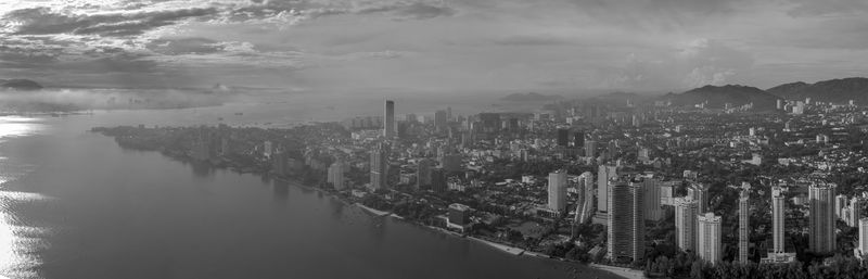 High angle view of river by buildings against sky