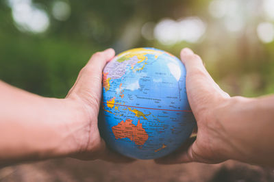 Close-up of hand holding globe