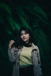 Portrait of beautiful young woman standing outdoors