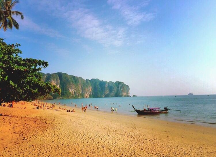 beach, sea, water, sand, shore, sky, vacations, scenics, tranquility, tranquil scene, beauty in nature, large group of people, tree, horizon over water, nature, nautical vessel, incidental people, leisure activity, tourism