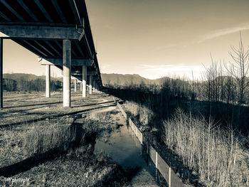 Bridge over river against sky during sunset