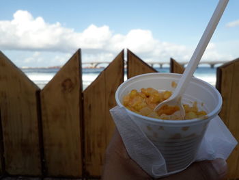 Close-up of hand holding ice cream in bowl