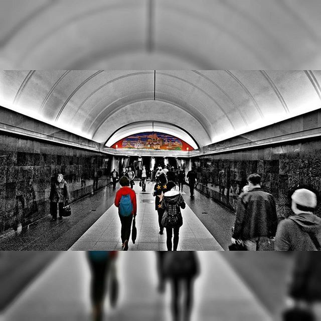 large group of people, men, indoors, architecture, person, built structure, walking, lifestyles, city life, railroad station, ceiling, leisure activity, travel, arch, public transportation, mixed age range, transportation, city, subway station