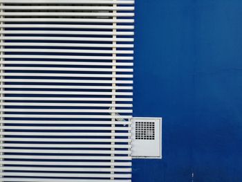 Railing against blue wall