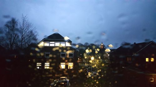 City buildings seen through wet glass window