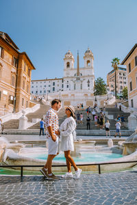 Full length of couple standing against histocial