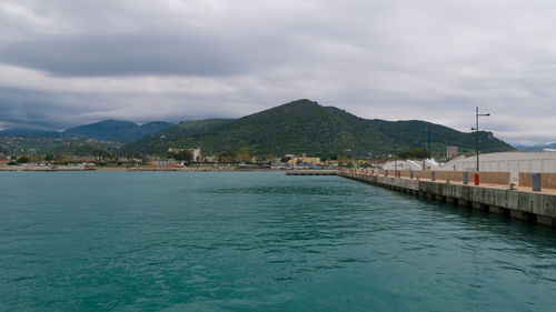 Scenic view of sea by buildings against sky