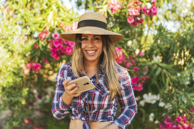 Portrait of young woman with telephone in her hand dressed in checkere