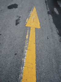 High angle view of arrow sign on road