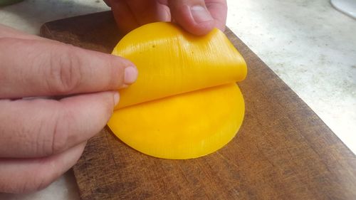 Close-up of person holding yellow food