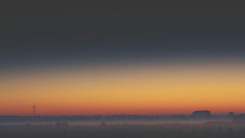 Scenic view of field against sky during sunset