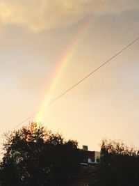 Scenic view of rainbow over trees