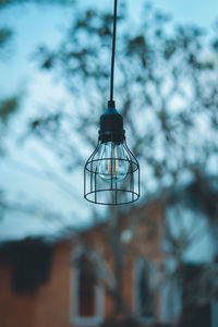 Low angle view of illuminated light bulb against sky