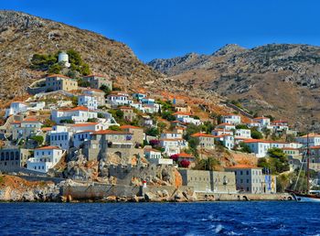 Town by sea against sky at hydra island