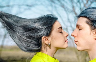 Young couple with blue hair embracing