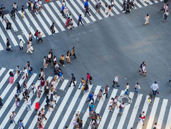 High angle view of people crossing road