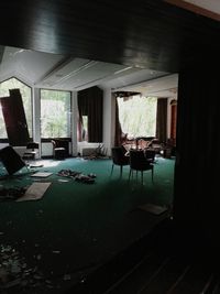 Empty chairs and tables in glass window