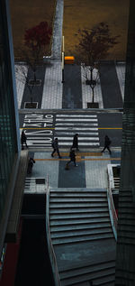 High angle view of people walking on staircase of building